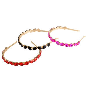 Detail of slim wire headbands with red, black, and rose red rhinestones on gold metal