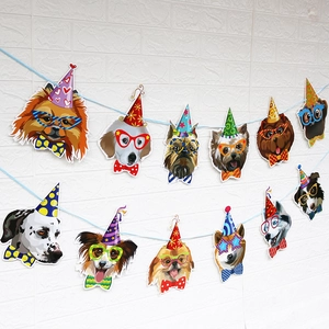 Close-up of cartoon dog faces with party hats on a happy birthday hanging banner