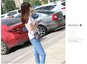 Detailed view of the mini floral crossbody phone bag with multi-zipper compartments