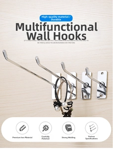 Close-up of four wall-mounted silver metal display hooks showing hair ties on wood background