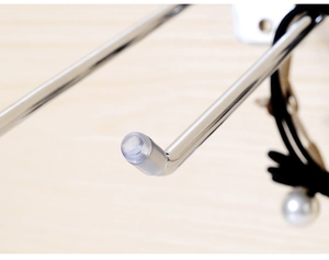 Detailed close-up of a metal slatwall hook featuring a clear protective tip for accessory display