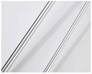 Detailed macro view of silver wall-mounted single hook with sleek metallic stripe texture