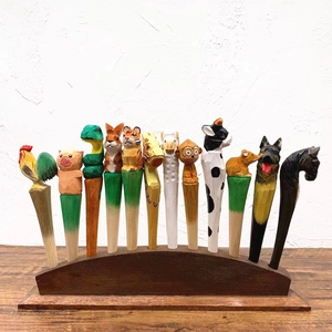 Detailed row of hand-carved wooden pens featuring colorful Chinese zodiac animal designs