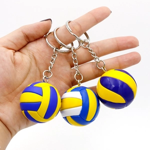 Detailed view of three volleyball keychains with classic blue, yellow, and white panels