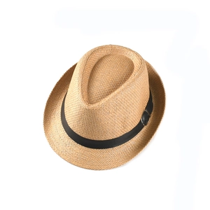 Detailed view of woven straw material and black decorative belt on kids jazz hat