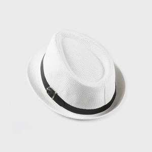 Close-up of white straw fedora hat featuring a black leather buckle band and fine texture