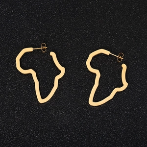 Golden stainless steel Africa map cutout stud earrings on a textured black background
