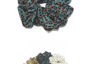 Detail of oversized leopard print and dotted scrunchies in textured pleated fabric