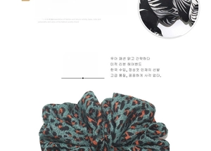 Detail view of large leopard print and leaf pattern fabric scrunchies for hair styling