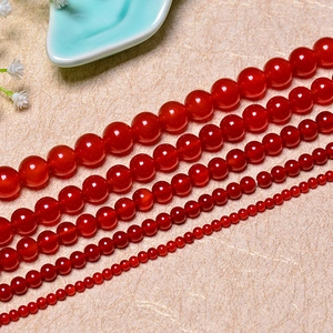 Natural red agate round beads for DIY jewelry making in various sizes on beige paper