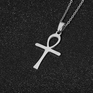 Detailed view of polished stainless steel Ankh cross pendant necklace on black background