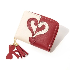 Short zipper wallet for women with red heart stitching and tassel on beige leather