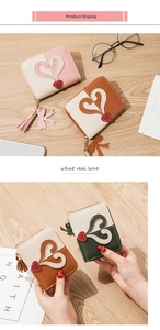 Detail of color-block PU leather wallet featuring heart patchwork and tassel zipper puller