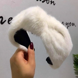 Detailed view of the soft white faux rabbit fur texture and knotted design on headband