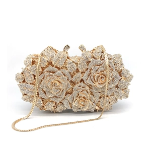 Detailed view of golden rose evening clutch with sparkling rhinestones and chain strap