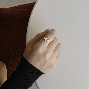 Detailed shot of 925 silver star and moon ring on hand with elegant minimalist design