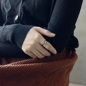 Close-up of minimalist 925 sterling silver ring featuring a moon and star design