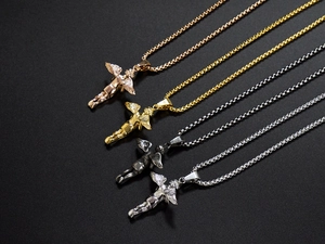 Macro view of gold and silver angel wing pendants with durable box chain in four finishes