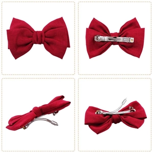 Deep red fabric bow hair clip with silver spring metal fastener in multi-angle views