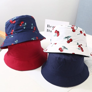 Kids reversible cherry print and solid color bucket hats in red, white and navy blue cotton