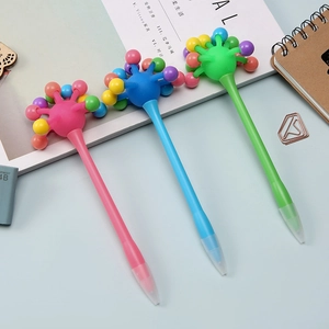Close-up of three colorful retractable gel pens with creative spherical tops for students
