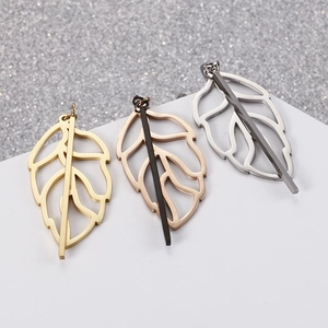 Three hollow leaf-shaped pendant earrings in gold, silver, and rose gold finishes