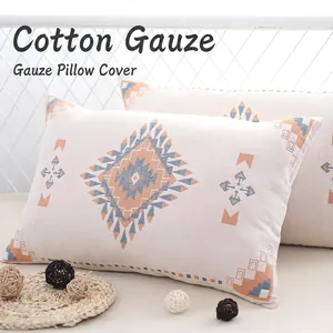 Pair of bohemian style cotton gauze pillowcases with blue and orange geometric patterns