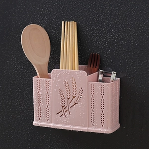 Pink wall-mounted plastic kitchen utensil holder with drain holes and wheat pattern