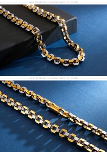 Detail of two-tone octagonal chain links and secure buckle in polished stainless steel