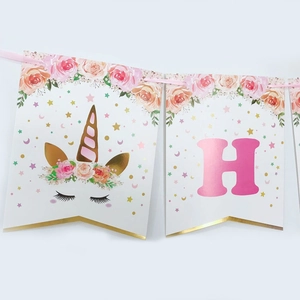 Detail of pink unicorn birthday banner with gold foil edging and floral cardstock letters