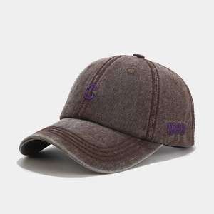Detail of vintage washed coffee baseball cap with purple C and 1999 side embroidery
