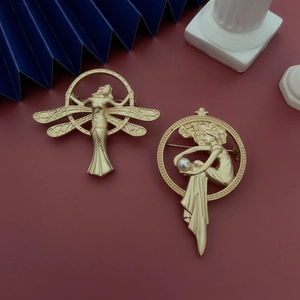 Detail of vintage matte gold angel brooches with dragonfly wings and pearls in Art Nouveau style