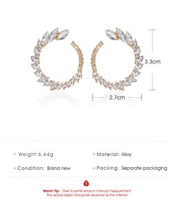 Detail view of rhinestone C-hoop earrings with 3.3cm height and 2.7cm width dimensions