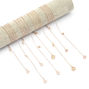 Rose gold chain with star and heart zircon charms for glasses or mask on a display roll