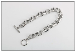 Close-up of silver titanium steel cable chain bracelet featuring a toggle clasp detail
