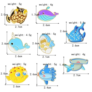Matrix display of eight colorful enamel sea creature pins including sharks and whales