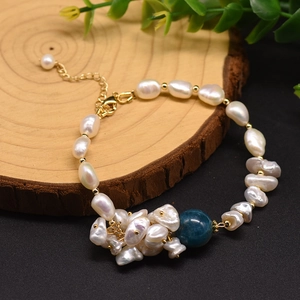 Macro detail of Baroque freshwater pearl bracelet with blue kyanite and gold clasp