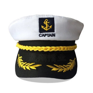 Close-up of golden captain embroidery and anchor pattern on white sailor hat