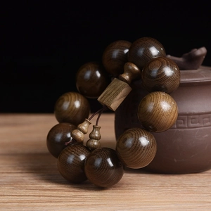 Detailed view of 25mm Phoebe wood beads with square plaque and gourd charms