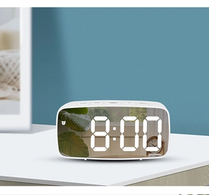 Close-up of top function buttons and white mirror LED clock face showing 8:00 time