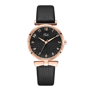 Fashion women's quartz watch with black leather strap and rose gold case on white background