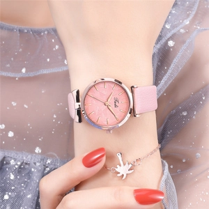 Close-up of Tadi pink leather watch featuring a rose gold bow lug and leaf pattern