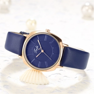 Close-up of deep blue leather strap and rose gold octagonal case with Tadi dial