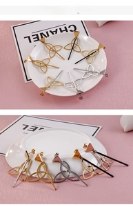 Detailed view of geometric triangle drop earrings in gold, silver, black and rose gold finishes
