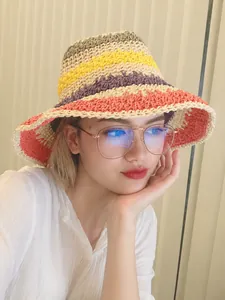 Detail of colorful crochet sun hat and round glasses in a casual indoor selfie setting