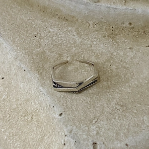Close-up of 925 sterling silver open ring with geometric hexagon and vintage texture