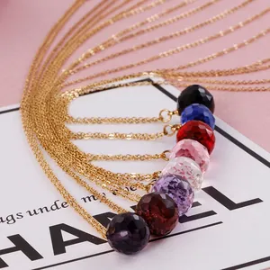 Minimalist crystal ball necklaces in eight vibrant colors with elegant gold chains