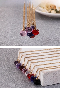 Detailed macro view of faceted crystal ball necklaces in seven vibrant colors