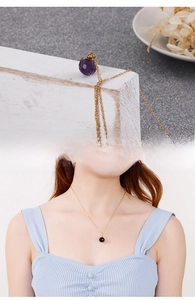 Detail view of crystal bead necklace in purple and black with gold titanium steel chain