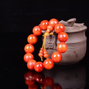 Macro view of 18mm blood dragon wood prayer beads with gourd pendant and oil finish